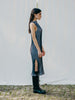 Swiss-made unique rib-knit cotton dress with pleated design, elegant high neckline, and chic side slits, perfect for evening wear or casual style, sustainable and made to order.