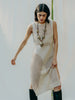 Sassy net knit dress crafted in Switzerland, featuring a classic round neckline, fitting armholes, and stylish side slits, made from organic cotton, perfect for evening wear or summer outings over swimwear